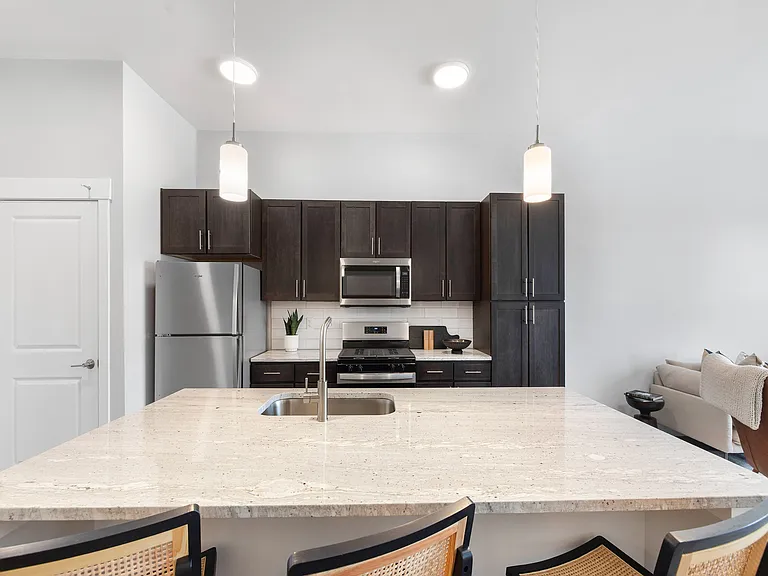 Open-plan kitchen with island and breakfast bar seating