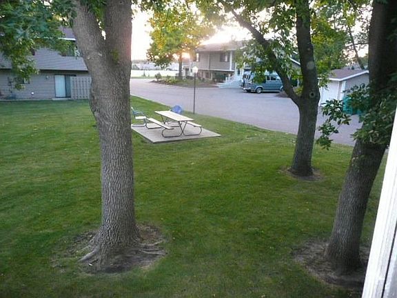 This home is located on the court yard canopied by full growth tress.