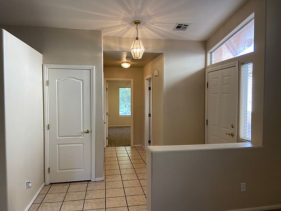 Beautiful large entry way leads into dining area with vaulted ceilings.