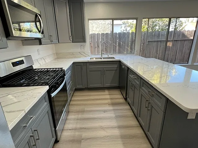 Luxury vinyl plank wood flooring, quartz countertops
