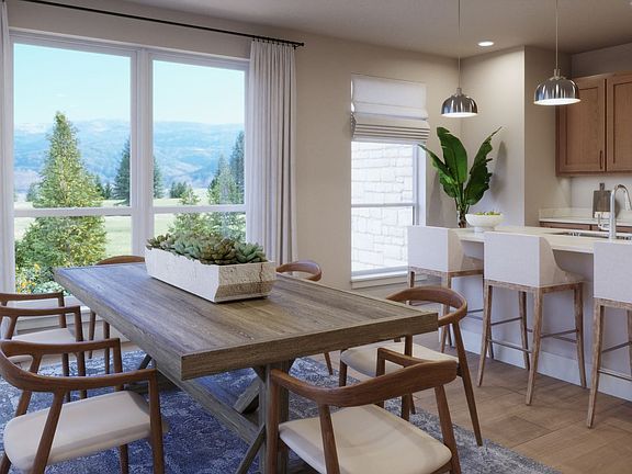 Designed for gathering and connection. This inviting dining space flows seamlessly into the kitchen,