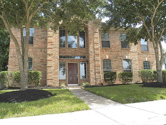 2-Story entry way with mature trees and great curb appeal.