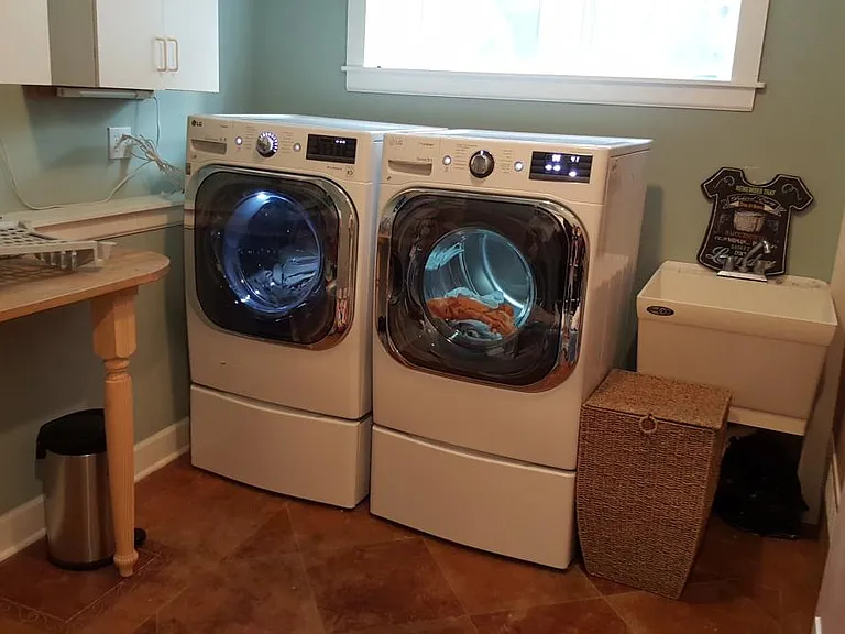 Laundry with brand new high-end washer and dryer.