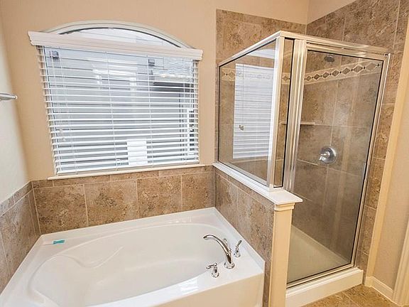 Master bathroom with double sink vanity, garden tub and a shower