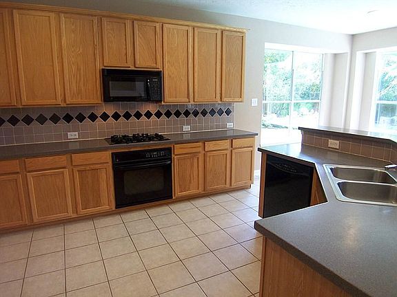 Lots of cabinet and counter space in this large , open kitchen, solid surface counter tops.