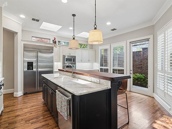 Kitchen with built-in refrigerator and breakfast bar
