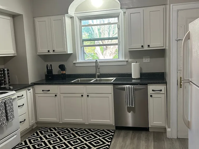 Large kitchen with back door access to basement (laundry room) and back yard.