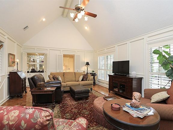 Gorgeous wood panel and elevated ceiling add to this inviting den.