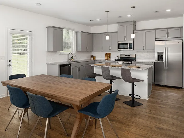 Spacious kitchen with an island, ample storage, and stainless steel appliances.