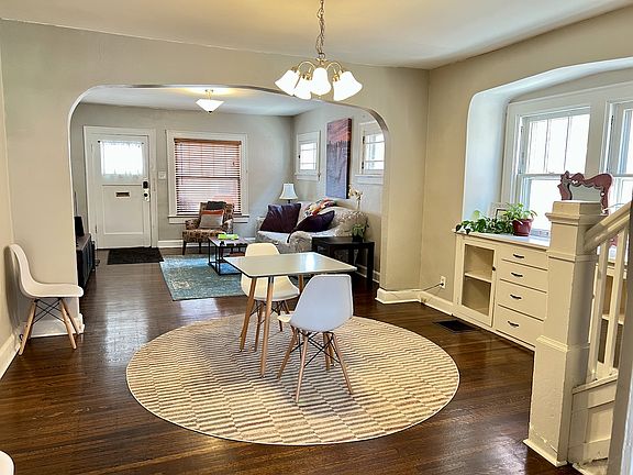 Living & dining area. Original quarter-sawn oak floors, arched openings, and built-ins