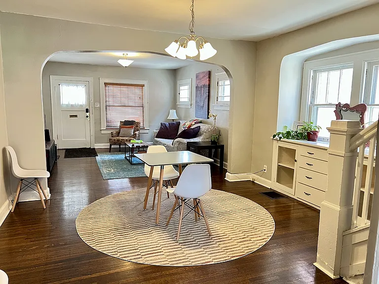 Living & dining area. Original quarter-sawn oak floors, arched openings, and built-ins