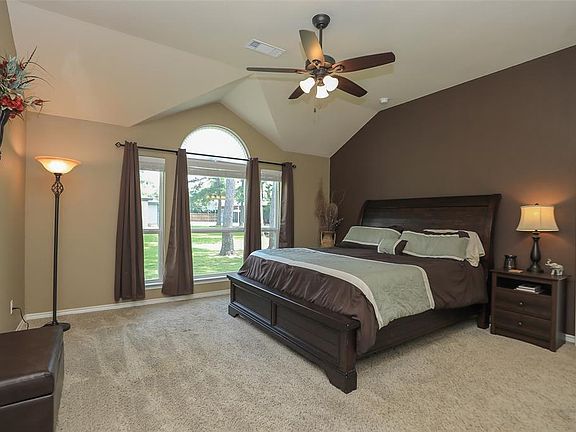 Beautiful master bedroom with high ceilings and large windows for natural lighting