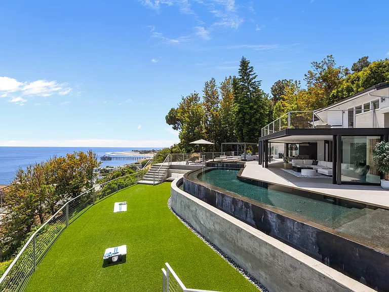 Challenge friends and family to a friendly game of cornhole on the expansive lawn, surrounded by stunning ocean vistas.