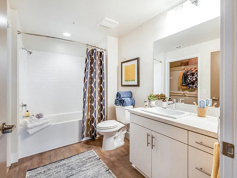 Bathrooms with modern frameless mirrors and closet storage