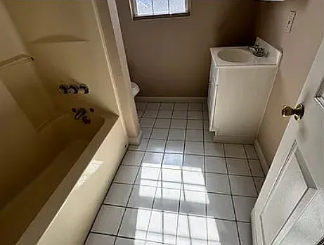 Updated bathroom with tile floor.