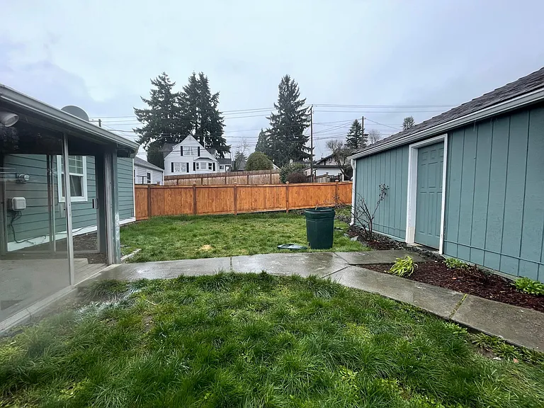 Back area between garage on the right and home on the left