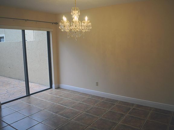 Open dining area overlooking walled and gated private patio.
