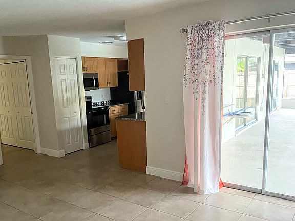 dining room opens to kitchen, with sliding glass door access to patio/ pool