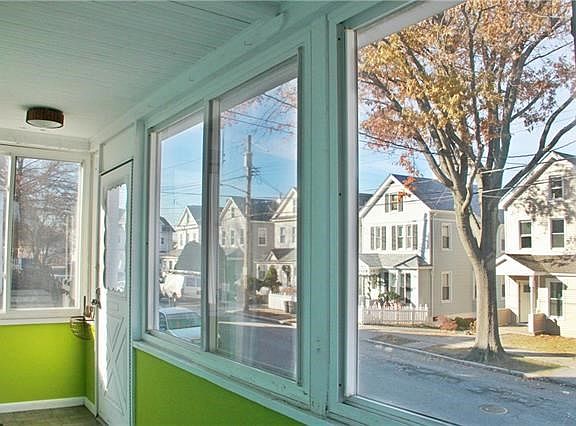 Charming street to watch the world go by from this sunny enclosed front porch.