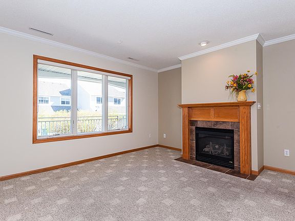 Main Floor - Living Room with Gas Fireplace and Crown Molding Ceiling