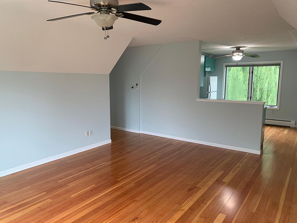 Living area looking into kitchen. Newly finished hardwood floors.