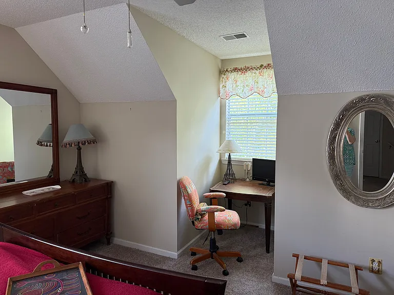 Primary bedroom with desk area