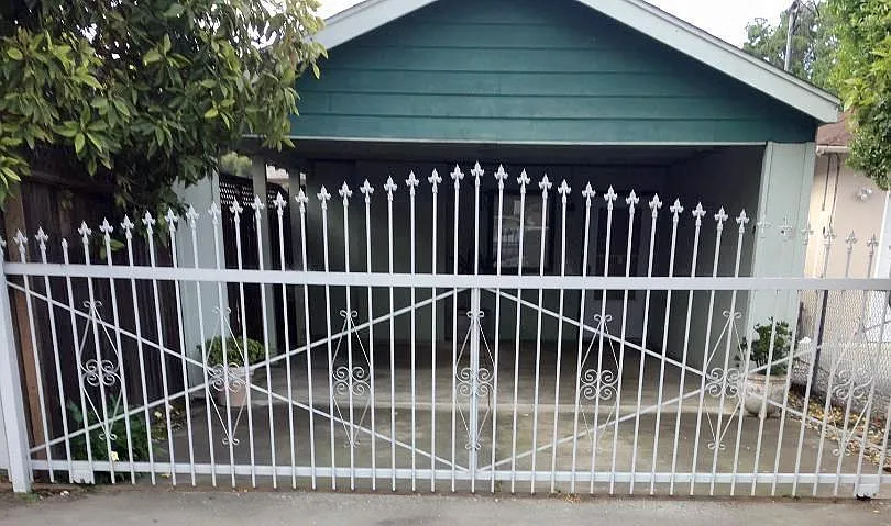 Covered 2Cars Carport And Wrought Iron Gate Entrance On Runnymede Street.