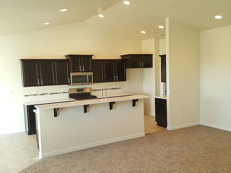 Open concept - Living, kitchen and dining areas (stainless steel fridge available; not shown here)