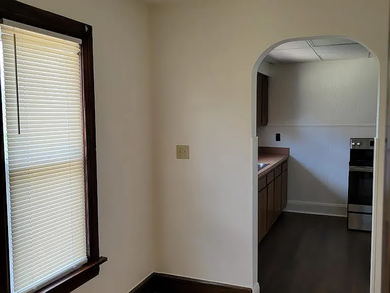 Breakfast nook leading to kitchen with new windows.