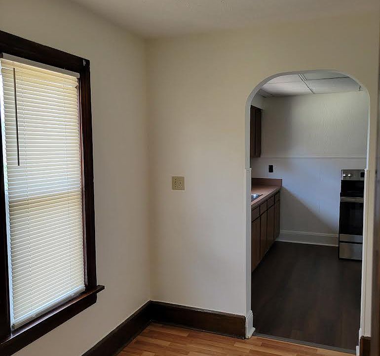 Breakfast nook leading to kitchen with new windows.