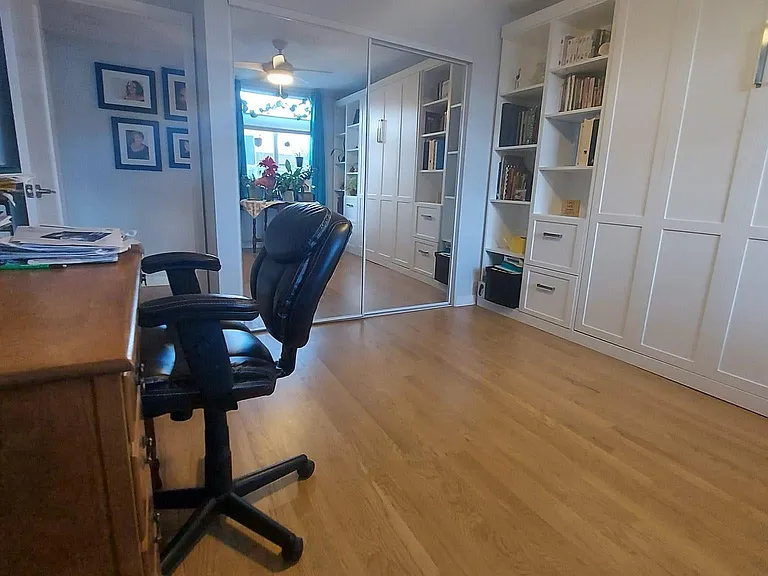 bedroom with large mirrored closets. (shelving unit not included)