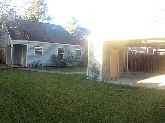 Backyard and carport with garage door