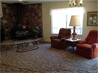 Family room that is open to the kitchen and has a sliding glass
