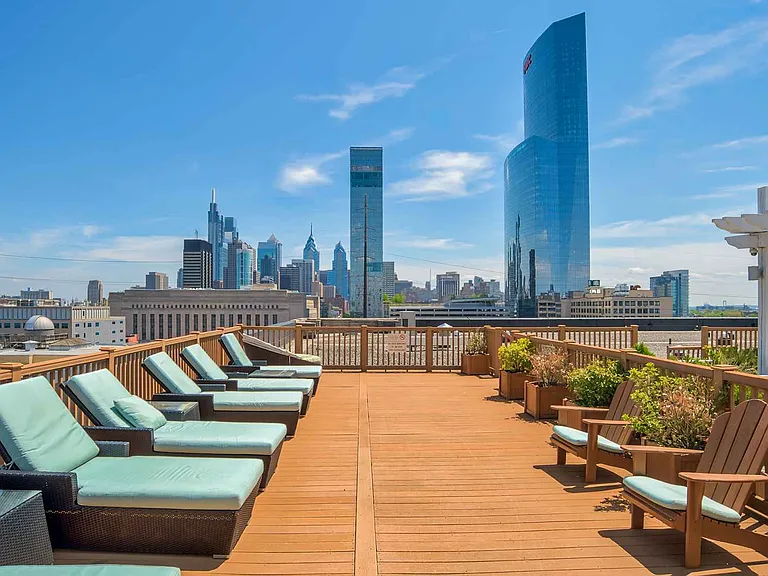 Spacious rooftop deck with sunbathing chairs