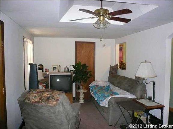 The living room features a ceiling fan.
