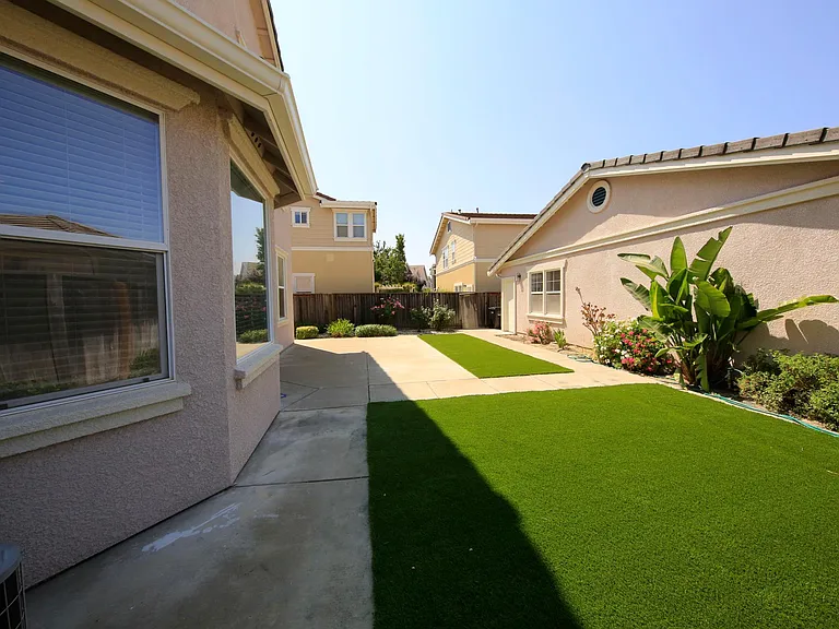 Back yard with Fake Grass and separate 3 Car garage