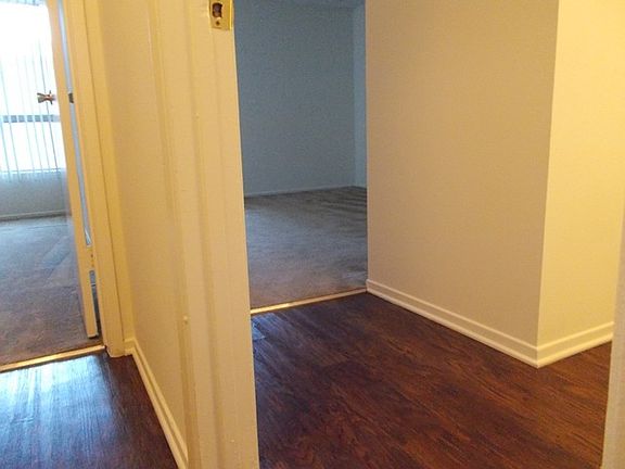 Wood floor goes to both bedrooms