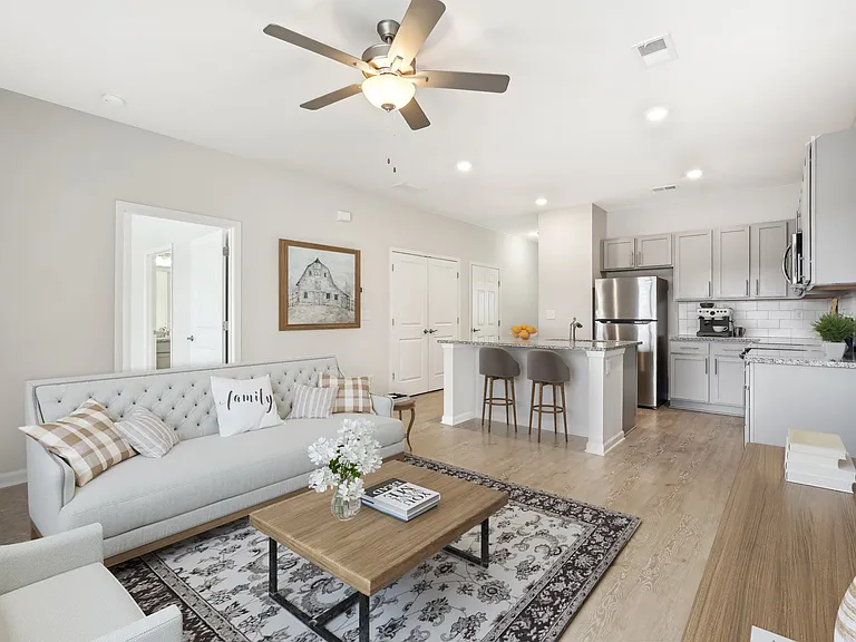 Spacious and open-concept layout. Showing the living room looking into the kitchen.
