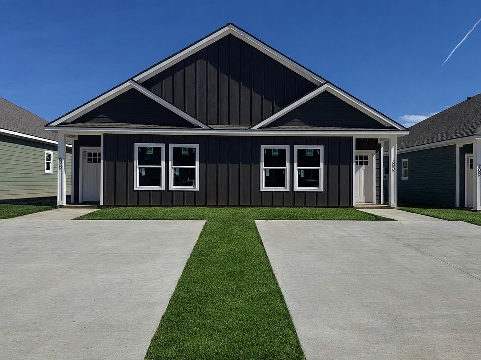 Brand-new 2BR/2BA duplex with private driveway and modern exterior.
