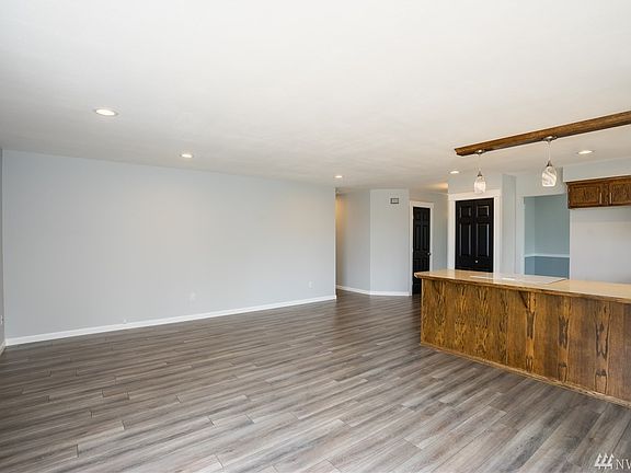 Standing in the family room with slider leading to the nicely sized composite deck with access to the back and side yard.  Note the new fencing and views!