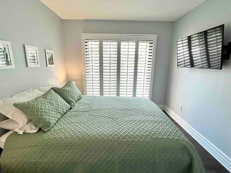 Bedroom #3 is adjacent to the living room with access to the front patio. Queen bed with 43" Roku TV.