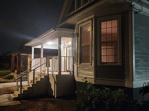 This is a night picture of front right of house