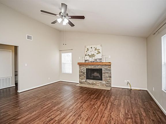 Hi ceilings and windows provide natural light. The windows are double paned. The fire place surround is stacked stone and is wood burning.