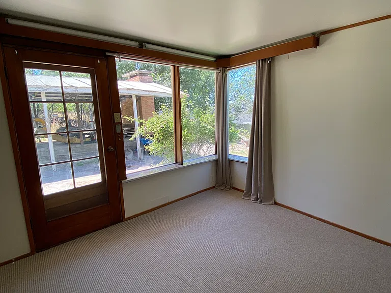 Bedroom 1, new carpet, large windows with door to small patio off the bedroom and larger patio for gatherings