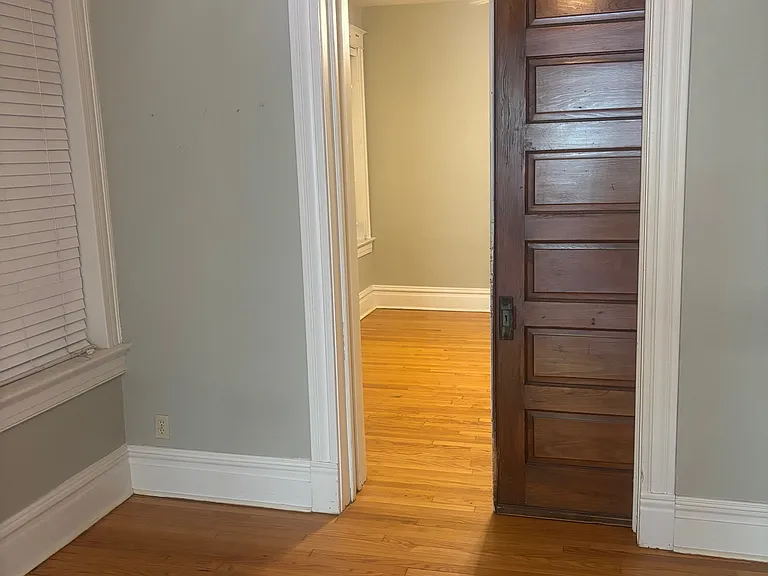Living Room toward Den/second Bedroom with pocket door partially closed