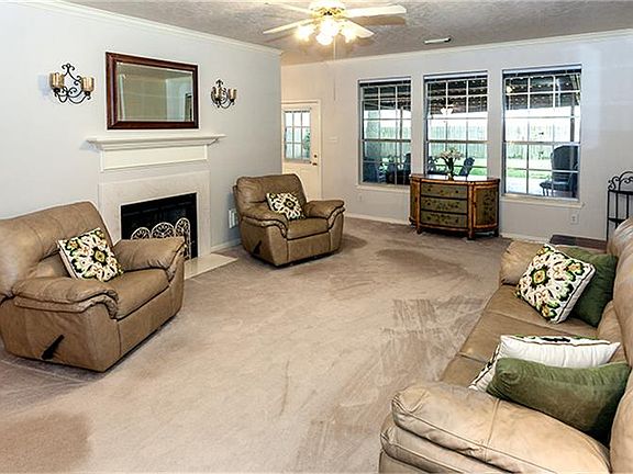 The Den boasts neutral colors & crown molding!