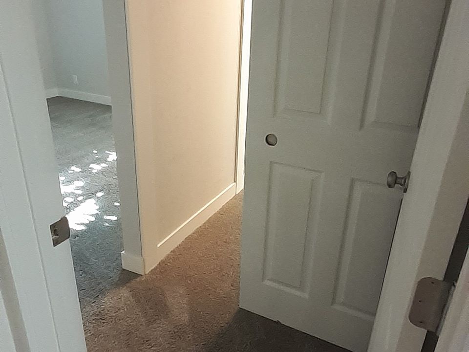 Entrance to master bedroom and view of closet.