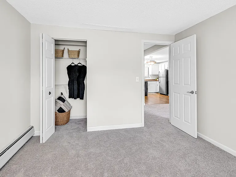 Experience the ease of wardrobe organization in our spacious closets with built-in open wire shelving for storage and functionality. Enhance your daily life with tidiness and style.