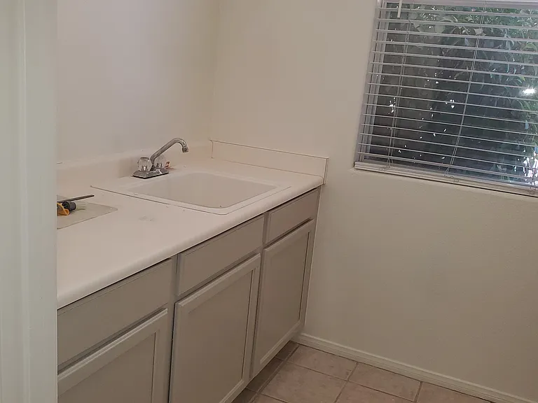 Laundry Areas with uitility sink, counter and cabinet