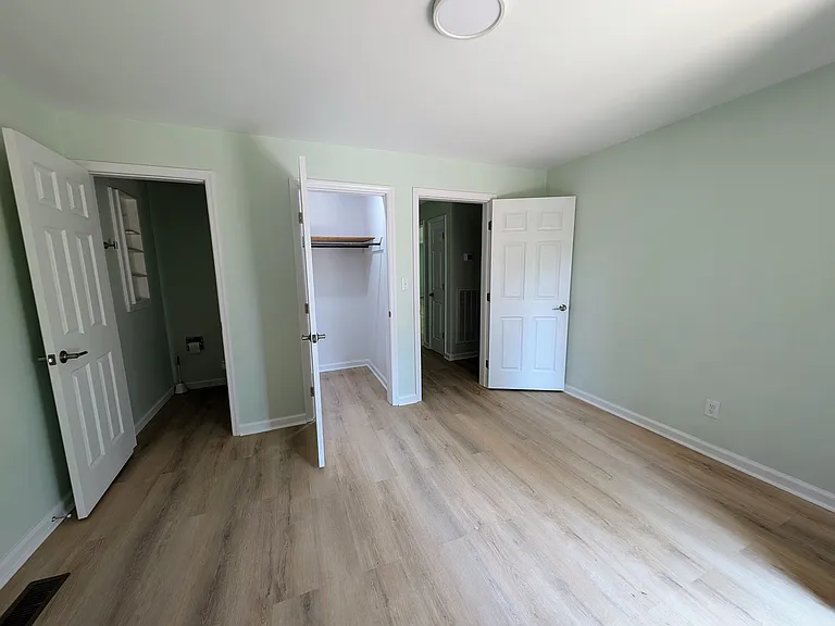 Middle bedroom looking toward half-bath and hall
